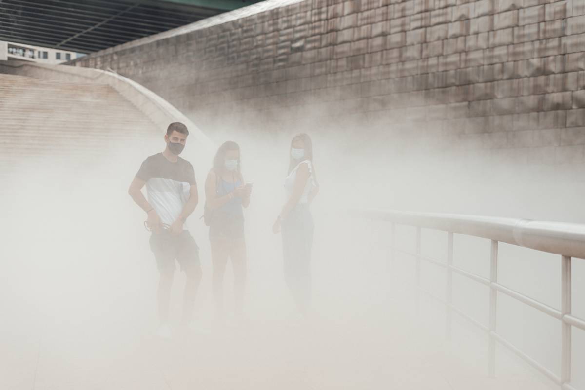 Three people with masks on a smog cloud